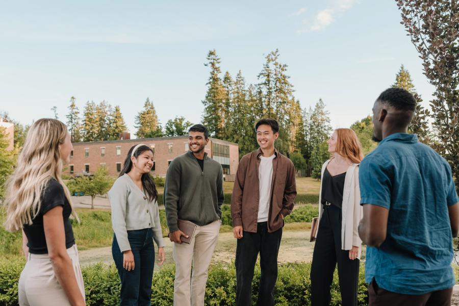 student standing in front of pond