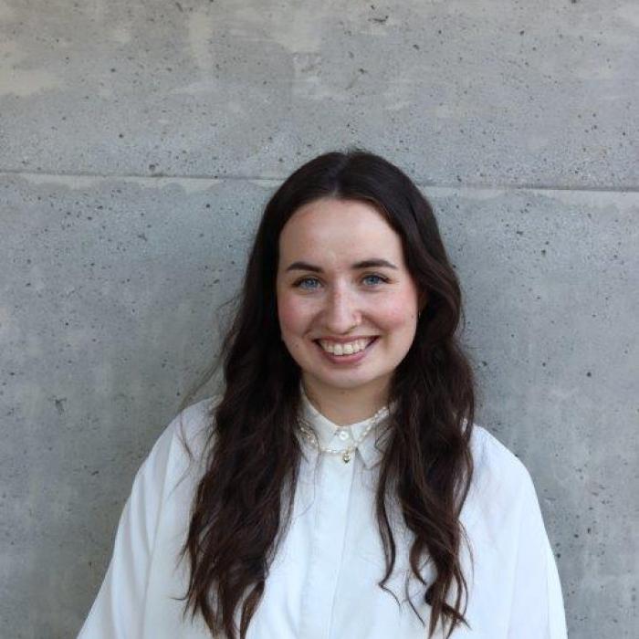 headshot of person in front of wall